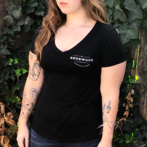 women wearing black v-neck tee with chest logo